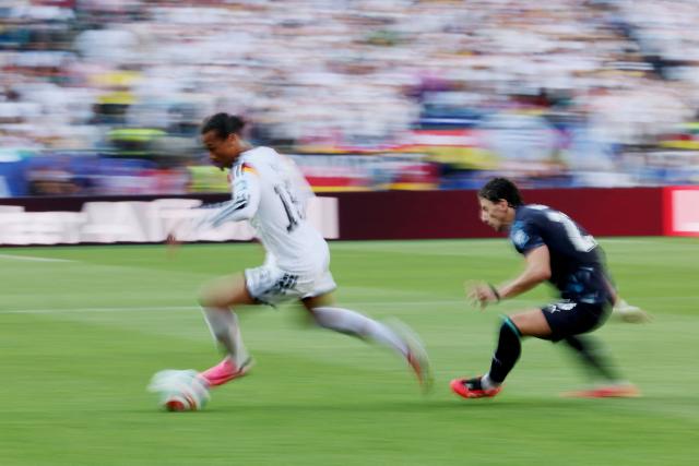 This slow shutter photograph shows Germany's forward #19 Leroy Sane (L) running with the ball past Paraguay's midfielder #23 Matias Galarza during the 2026 World Cup round of 32 football match between Germany and Paraguay at the Boston Stadium in Foxborough on June 29, 2026.  (Photo by Odd ANDERSEN / AFP)