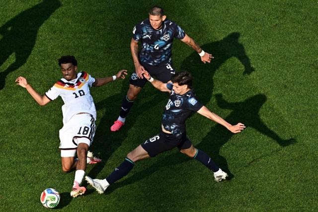 Germany's defender #18 Nathaniel Brown AND Paraguay's midfielder #16 Damian Bobadilla fight for the ball during the 2026 World Cup round of 32 football match between Germany and Paraguay at the Boston Stadium in Foxborough on June 29, 2026.  (Photo by Jewel SAMAD / AFP)