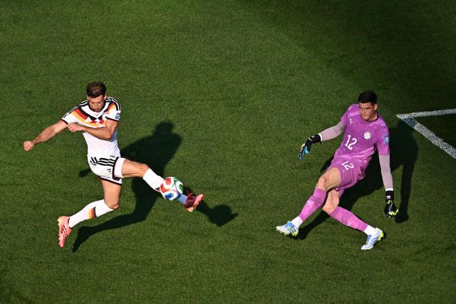 Paraguay's goalkeeper #12 Orlando Gill (R) kicks the ball past Germany's midfielder #08 Leon Goretzka during the 2026 World Cup round of 32 football match between Germany and Paraguay at the Boston Stadium in Foxborough on June 29, 2026.  (Photo by Jewel SAMAD / AFP)