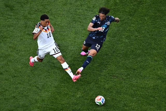 Germany's midfielder #10 Jamal Musiala and Paraguay's defender #13 Jose Canale fight for the ball during the 2026 World Cup round of 32 football match between Germany and Paraguay at the Boston Stadium in Foxborough on June 29, 2026.  (Photo by Jewel SAMAD / AFP)