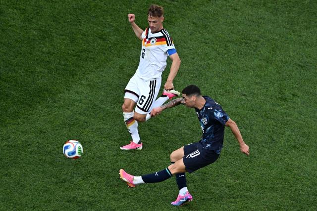 Paraguay's midfielder #10 Miguel Almiron kicks the ball past Germany's defender #06 Joshua Kimmich during the 2026 World Cup round of 32 football match between Germany and Paraguay at the Boston Stadium in Foxborough on June 29, 2026.  (Photo by Jewel SAMAD / AFP)