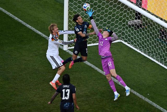 Paraguay's goalkeeper #12 Orlando Gill (R) makes a save past Paraguay's defender #15 Gustavo Gomez (C) and Germany's forward #11 Nick Woltemade (L) during the 2026 World Cup round of 32 football match between Germany and Paraguay at the Boston Stadium in Foxborough on June 29, 2026.  (Photo by Jewel SAMAD / AFP)