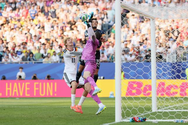 Paraguay's goalkeeper #12 Orlando Gill (R) makes a save past Paraguay's defender #15 Gustavo Gomez (C) and Germany's forward #11 Nick Woltemade (L) during the 2026 World Cup round of 32 football match between Germany and Paraguay at the Boston Stadium in Foxborough on June 29, 2026.  (Photo by Odd ANDERSEN / AFP)