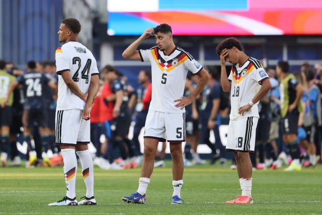 Germany's defender #24 Malick Thiaw, defender #05 Aleksandar Pavlovic, and defender #18 Nathaniel Brown react after losing the penalty shootout of the 2026 World Cup round of 32 football match between Germany and Paraguay at the Boston Stadium in Foxborough on June 29, 2026.  (Photo by Odd ANDERSEN / AFP)