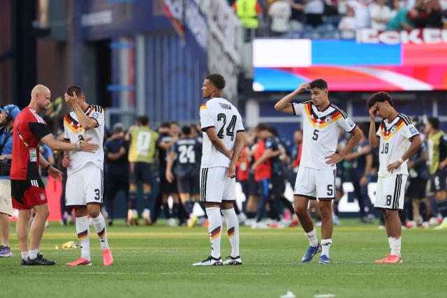 Germany's defender #03 Waldemar Anton, defender #24 Malick Thiaw, defender #05 Aleksandar Pavlovic, and defender #18 Nathaniel Brown react after losing the penalty shootout of the 2026 World Cup round of 32 football match between Germany and Paraguay at the Boston Stadium in Foxborough on June 29, 2026.  (Photo by Odd ANDERSEN / AFP)