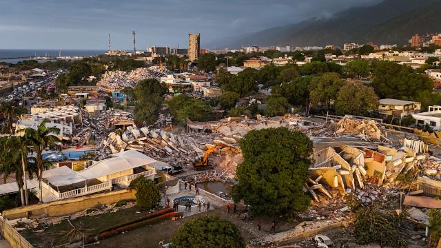 This aerial view shows buildings destroyed following twin earthquakes in Caraballeda, La Guaira State, Venezuela, on June 29, 2026. Volunteers and emergency brigades with rescue dogs continue lifting mountains of rubble in search of survivors of the twin earthquake that struck Venezuela four days ago, which completely brought down nearly 200 buildings and left at least 1,450 dead and tens of thousands missing. (Photo by Miguel MEDINA / AFP)