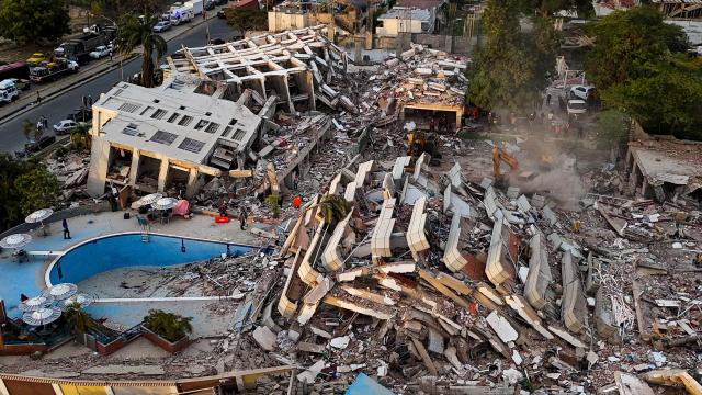 This aerial view shows buildings destroyed following twin earthquakes in Caraballeda, La Guaira State, Venezuela, on June 29, 2026. Volunteers and emergency brigades with rescue dogs continue lifting mountains of rubble in search of survivors of the twin earthquake that struck Venezuela four days ago, which completely brought down nearly 200 buildings and left at least 1,450 dead and tens of thousands missing. (Photo by Miguel MEDINA / AFP)