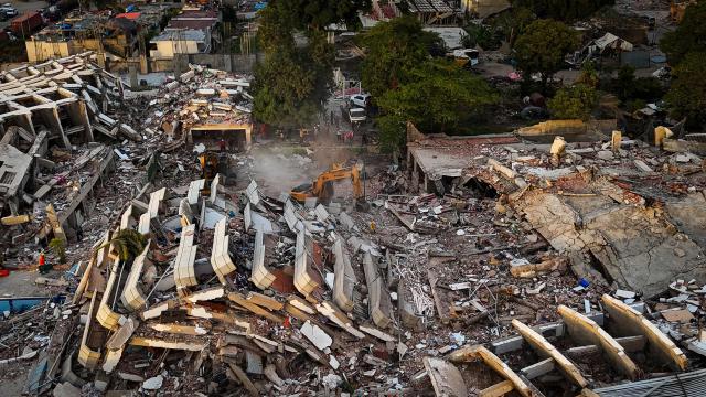 This aerial view shows buildings destroyed following twin earthquakes in Caraballeda, La Guaira State, Venezuela, on June 29, 2026. Volunteers and emergency brigades with rescue dogs continue lifting mountains of rubble in search of survivors of the twin earthquake that struck Venezuela four days ago, which completely brought down nearly 200 buildings and left at least 1,450 dead and tens of thousands missing. (Photo by Miguel MEDINA / AFP)