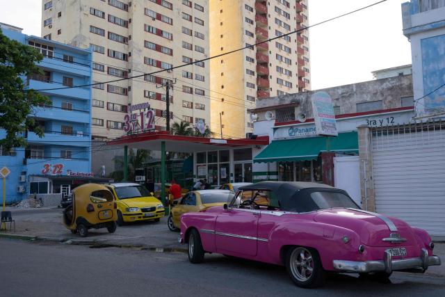 Cars queue to refuel at a petrol station in Havana on June 23, 2026. Food, transport and even fuel imports: the private sector, once marginal, is now establishing itself in a Cuba in crisis and is set to grow further following the recent liberalisation measures approved by the government. (Photo by PABLO  PORCIUNCULA / AFP)