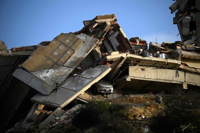 This view shows a collapsed concrete structure with crushed floors and debris, with a car partially buried beneath, in the Playa Verde sector of Catia La Mar, La Guaira state, Venezuela, on June 29, 2026, following twin earthquakes. Hopes were fading of finding survivors more than four days after powerful twin earthquakes struck Venezuela, as residents grow increasingly frustrated with the government's response to the disaster that has killed -up to now- more than 1,700 people and left tens of thousands unaccounted for. (Photo by Federico PARRA / POOL / AFP)