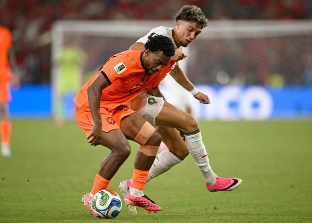 Netherlands' midfielder #26 Quinten Timber and Morocco's midfielder #24 Neil El Aynaoui fight for the ball during the 2026 World Cup round of 32 football match between the Netherlands and Morocco at the Monterrey Stadium in Guadalupe on June 29, 2026.  (Photo by Alfredo ESTRELLA / AFP)