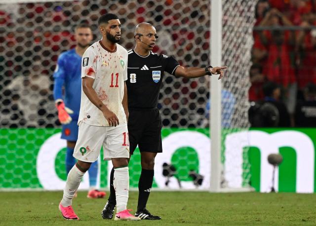 Brazilian referee Wilton Sampaio helps Morocco's midfielder #11 Ismael Saibari to leave the field bleeding during the 2026 World Cup round of 32 football match between the Netherlands and Morocco at the Monterrey Stadium in Guadalupe on June 29, 2026.  (Photo by Alfredo ESTRELLA / AFP)