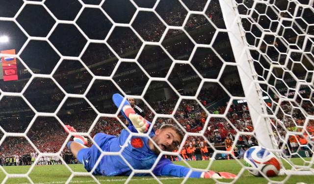 Netherlands goalkeeper #01 Bart Verbruggen concedes a penalty goal by Morocco forward #09 Soufiane Rahimi during the penalty shootout of the 2026 World Cup round of 32 football match between the Netherlands and Morocco at the Monterrey Stadium in Guadalupe on June 29, 2026.  (Photo by Alfredo ESTRELLA / AFP)