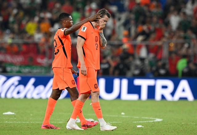 Netherlands' defender #22 Denzel Dumfries and forward #09 Wout Weghorst react after losing the penalty shootout of the 2026 World Cup round of 32 football match between the Netherlands and Morocco at the Monterrey Stadium in Guadalupe on June 29, 2026.  (Photo by Alfredo ESTRELLA / AFP)