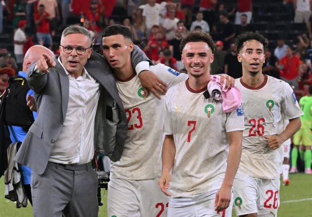 Morocco's head coach Mohamed Ouahbi celebrates with his players midfielder #23 Bilal El Khannouss, forward #07 Chemsdine Talbi and defender #26 Anass Salah-Eddine after winning the penalty shootout of the 2026 World Cup round of 32 football match between the Netherlands and Morocco at the Monterrey Stadium in Guadalupe on June 29, 2026.  (Photo by CARL DE SOUZA / AFP)