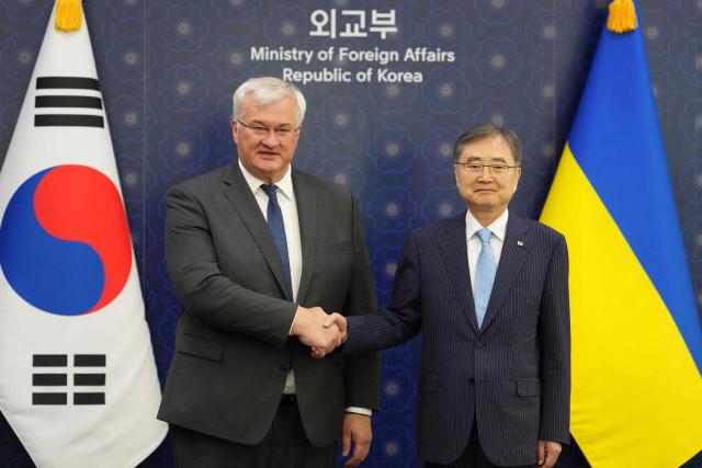 Ukraine's Foreign Minister Andrii Sybiha (L) shakes hands with South Korea's Foreign Minister Cho Hyun ahead of their meeting at the Foreign Ministry in Seoul on June 30, 2026. (Photo by Lee Jin-man / POOL / AFP)