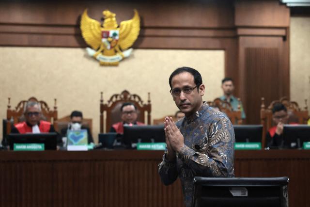 Nadiem Makarim, Indonesia's former education minister and co-founder of ride hailing company Gojek, gestures during a verdict hearing at the Central Jakarta District Court in Jakarta on June 30, 2026, in a corruption case related to the procurement of Chromebook laptops for schools during the Covid-19 pandemic. An Indonesian court is set to issue a verdict on June 30 in the corruption trial of former education minister Nadiem Makarim, a businessman who had left a multibillion-dollar startup to join government. (Photo by YASUYOSHI CHIBA / AFP)