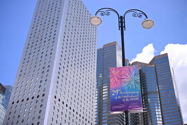 A banner marking the 29th anniversary of the handover of Hong Kong from Britain to China is seen on a street in Hong Kong on June 30, 2026. (Photo by Peter PARKS / AFP)