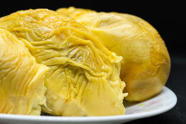 This photo taken on June 30, 2026 shows Black Thorn durian pulp served on a plate in Karak, in Malaysia's Pahang state. Found across Southeast Asia, the spiky fruit comes in many varieties and in Malaysia, the highly prized cultivar Musang King is consumed locally and exported, mainly to China. Malaysia, which produces more than 550,000 tonnes of durian a year, is currently in its peak harvest season. (Photo by Mohd Rasfan / AFP)