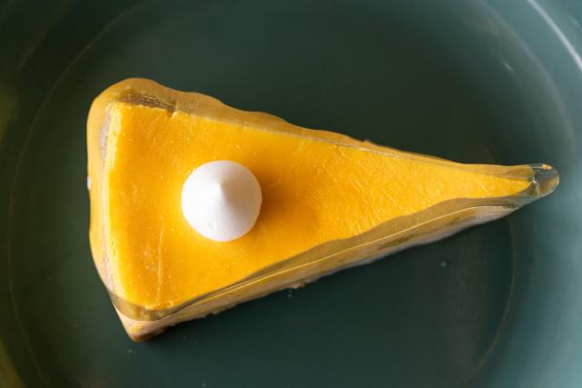 This photo taken on June 27, 2026 shows a Musang King cheesecake, which uses the prized durian variety as one of its main ingredient, in Karak, in Malaysia's Pahang state. Found across Southeast Asia, the spiky fruit comes in many varieties and in Malaysia, the highly prized cultivar Musang King is consumed locally and exported, mainly to China. Malaysia, which produces more than 550,000 tonnes of durian a year, is currently in its peak harvest season. (Photo by Mohd Rasfan / AFP)