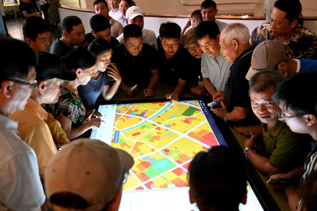 People view an exhibition for Hanoi's 100-year development master plan at the Hanoi Museum in Hanoi on June 30, 2026. (Photo by Nhac NGUYEN / AFP)