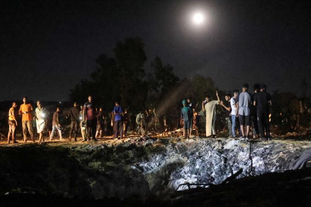 Palestinians gather at the site of an Israeli strike that was reportedly preceded by an Israeli military evacuation warning, at the al-Mawassi camp in Khan Yunis, southern Gaza Strip, late on June 29, 2026. Gaza remains gripped by daily violence, with both the Israeli military and Hamas accusing one another of violating the truce in effect since October 10. (Photo by Bashar Taleb / AFP)