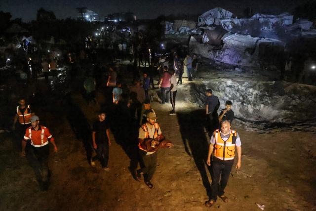 Palestinian emergency personnel stand at the site of an Israeli strike that was reportedly preceded by an Israeli military evacuation warning, at the al-Mawassi camp in Khan Yunis, southern Gaza Strip, late on June 29, 2026. Gaza remains gripped by daily violence, with both the Israeli military and Hamas accusing one another of violating the truce in effect since October 10. (Photo by Bashar Taleb / AFP)