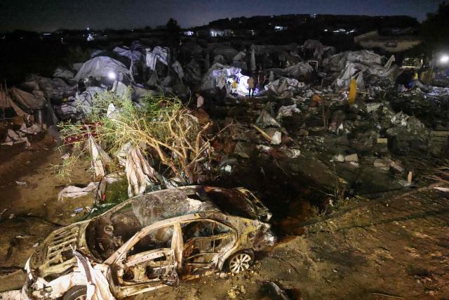 Palestinians stand amid destroyed shelters at the site of an Israeli strike that was reportedly preceded by an Israeli military evacuation warning, at the al-Mawassi camp in Khan Yunis, southern Gaza Strip, late on June 29, 2026. Gaza remains gripped by daily violence, with both the Israeli military and Hamas accusing one another of violating the truce in effect since October 10. (Photo by Bashar Taleb / AFP)