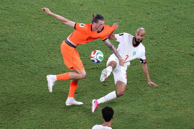 TOPSHOT - Netherlands' forward #09 Wout Weghorst and Morocco's defender #03 Noussair Mazraoui fight for the ball during the 2026 World Cup round of 32 football match between the Netherlands and Morocco at the Monterrey Stadium in Guadalupe on June 29, 2026.  (Photo by Julio Cesar AGUILAR / AFP)