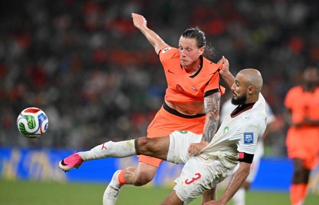 TOPSHOT - Netherlands' forward #09 Wout Weghorst and Morocco's defender #03 Noussair Mazraoui fight for the ball during the 2026 World Cup round of 32 football match between the Netherlands and Morocco at the Monterrey Stadium in Guadalupe on June 29, 2026.  (Photo by CARL DE SOUZA / AFP)