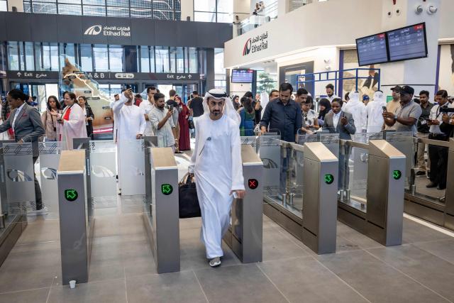 A passenger arrives at Mohamed bin Zayed City Station in Abu Dhabi on June 30, 2026, on the day of the inaugural journey of the UAE's first passenger train. The passenger service will eventually connect four of the country's seven emirates, with an "introductory operational phase" between Abu Dhabi and Fujairah to begin on June 30, state news agency WAM said earlier this month. The Dubai station will open on September 30, while the main station in the neighbouring emirate of Sharjah is set to be operational on March 30, 2027. (Photo by FADEL SENNA / AFP)