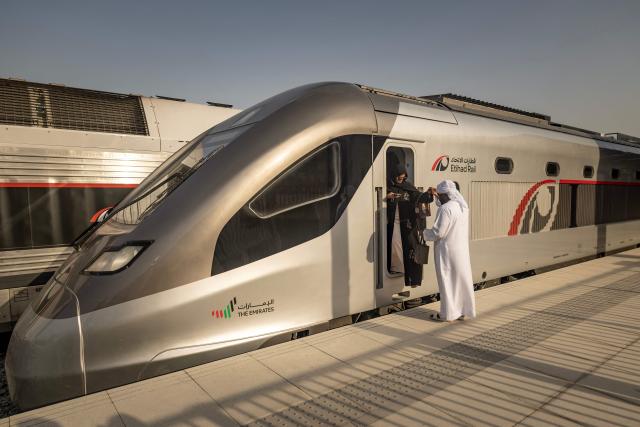 A woman exits the locomotive while touring an Etihad Rail train, the UAE's first passenger train, on its inaugural journey at Mohamed bin Zayed City station in Abu Dhabi on June 30, 2026. The passenger service will eventually connect four of the country's seven emirates, with an "introductory operational phase" between Abu Dhabi and Fujairah to begin on June 30, state news agency WAM said earlier this month. The Dubai station will open on September 30, while the main station in the neighbouring emirate of Sharjah is set to be operational on March 30, 2027. (Photo by FADEL SENNA / AFP)