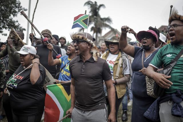 Protesters chant slogans as they gather during a demonstration by members of the "March and March" movement marking an unofficial deadline set by citizen-led groups for undocumented foreign nationals to leave South Africa, in Durban, on June 30, 2026. South African police deployed to head off unrest and protests on June 30, 2026, the unofficial deadline set by anti-immigrant groups for undocumented foreign nationals to leave that has already pushed thousands to flee.
Officers were out in force to prevent violence and looting by the xenophobic groups, while hundreds of foreign nationals took refuge in several cities, urgently seeking help to leave. (Photo by Rajesh JANTILAL / AFP)