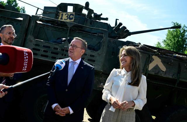 Dutch Defence Minister Dilan Yesilgoz-Zegerius (R) and German Defence Minister Boris Pistorius speak to journalists in front of a General Dynamics combat infantry vehicle in Valka, Latvia, on the border with Estonia, during a NATO Change of Command ceremony on June 30, 2026 in Valka (Latvia) or Valga (Estonia). A joint German-Dutch army corps (1GNC) is taking command of NATO land forces in Latvia and Estonia. Officially transitioning on June 30, 2026, this move establishes a dedicated second corps headquarters on the eastern flank to speed up reinforcements and command combat operations in the Baltic region. (Photo by John MACDOUGALL / AFP)