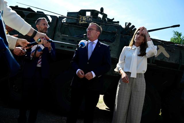 Dutch Defence Minister Dilan Yesilgoz-Zegerius (R) and German Defence Minister Boris Pistorius speak to journalists in front of a General Dynamics combat infantry vehicle in Valka, Latvia, on the border with Estonia, during a NATO Change of Command ceremony on June 30, 2026 in Valka (Latvia) or Valga (Estonia). A joint German-Dutch army corps (1GNC) is taking command of NATO land forces in Latvia and Estonia. Officially transitioning on June 30, 2026, this move establishes a dedicated second corps headquarters on the eastern flank to speed up reinforcements and command combat operations in the Baltic region. (Photo by John MACDOUGALL / AFP)