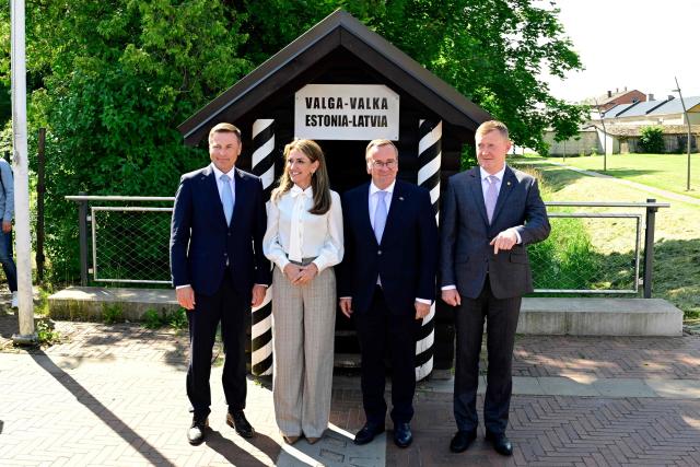 (L-R) Estonian Defence Minister Hanno Pevkur, Dutch Defence Minister Dilan Yesilgoz-Zegerius, German Defence Minister Boris Pistorius and Latvia's Defence Minister Raivis Melnis stand on the border crossing between Estonia (L) and Latvia (R) as they attend a NATO Change of Command ceremony on June 30, 2026 in Valka (Latvia) or Valga (Estonia). A joint German-Dutch army corps (1GNC) is taking command of NATO land forces in Latvia and Estonia. Officially transitioning on June 30, 2026, this move establishes a dedicated second corps headquarters on the eastern flank to speed up reinforcements and command combat operations in the Baltic region. (Photo by John MACDOUGALL / AFP)