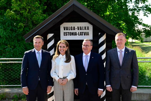 (L-R) Estonian Defence Minister Hanno Pevkur, Dutch Defence Minister Dilan Yesilgoz-Zegerius, German Defence Minister Boris Pistorius and Latvia's Defence Minister Raivis Melnis stand on the border crossing between Estonia (L) and Latvia (R) as they attend a NATO Change of Command ceremony on June 30, 2026 in Valka (Latvia) or Valga (Estonia). A joint German-Dutch army corps (1GNC) is taking command of NATO land forces in Latvia and Estonia. Officially transitioning on June 30, 2026, this move establishes a dedicated second corps headquarters on the eastern flank to speed up reinforcements and command combat operations in the Baltic region. (Photo by John MACDOUGALL / AFP)