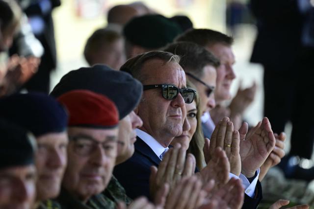 German Defence Minister Boris Pistorius (C) applauds as he attends a NATO Change of Command ceremony on June 30, 2026 in Valka (Latvia) or Valga (Estonia). A joint German-Dutch army corps (1GNC) is taking command of NATO land forces in Latvia and Estonia. Officially transitioning on June 30, 2026, this move establishes a dedicated second corps headquarters on the eastern flank to speed up reinforcements and command combat operations in the Baltic region. (Photo by John MACDOUGALL / AFP)