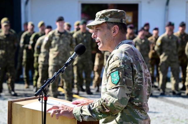 US General Chris Donahue, outgoing US commander of NATO's land forces in Europe, addresses soldiers in Valka, Latvia, on the border with Estonia, during a NATO Change of Command ceremony on June 30, 2026 in Valka (Latvia) or Valga (Estonia). A joint German-Dutch army corps (1GNC) is taking command of NATO land forces in Latvia and Estonia. Officially transitioning on June 30, 2026, this move establishes a dedicated second corps headquarters on the eastern flank to speed up reinforcements and command combat operations in the Baltic region. (Photo by John MACDOUGALL / AFP)