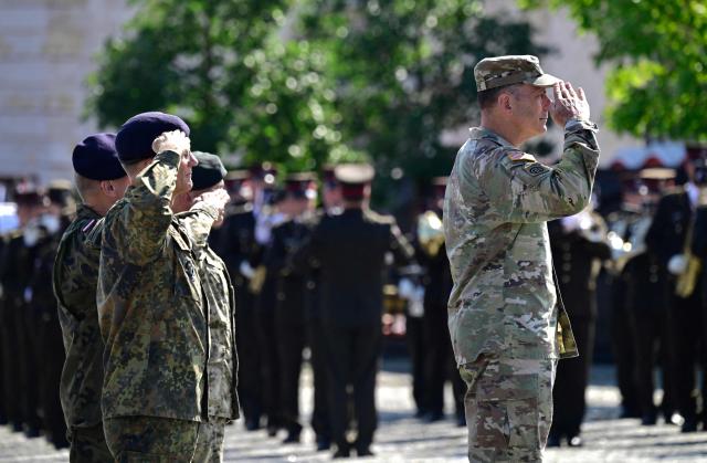 US General Chris Donahue (R), outgoing US commander of NATO's land forces in Europe, is saluting in Valga, Estonia, on the border with Latvia, during a NATO Change of Command ceremony on June 30, 2026 in Valka (Latvia) or Valga (Estonia). A joint German-Dutch army corps (1GNC) is taking command of NATO land forces in Latvia and Estonia. Officially transitioning on June 30, 2026, this move establishes a dedicated second corps headquarters on the eastern flank to speed up reinforcements and command combat operations in the Baltic region. (Photo by John MACDOUGALL / AFP)