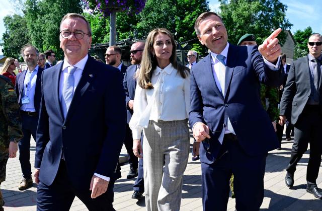 (From L) Germany's Defence Minister Boris Pistorius, Dutch Defence Minister Dilan Yesilgoz-Zegerius and Estonia's Defence Minister Hanno Pevkur walk back to the Estonian side of the border after a press conference on the Latvian side, during a NATO Change of Command ceremony on June 30, 2026 in Valka (Latvia) or Valga (Estonia). A joint German-Dutch army corps (1GNC) is taking command of NATO land forces in Latvia and Estonia. Officially transitioning on June 30, 2026, this move establishes a dedicated second corps headquarters on the eastern flank to speed up reinforcements and command combat operations in the Baltic region. (Photo by John MACDOUGALL / AFP)