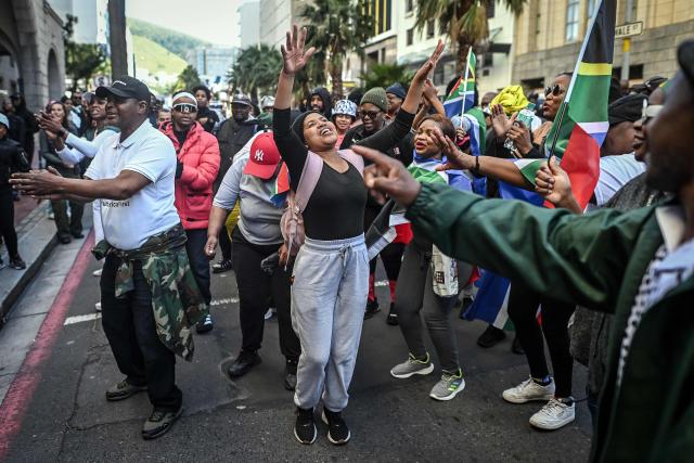 Protesters chant slogans as they march during a demonstration by the "March and March" and Operation Dudula movements marking an unofficial deadline set by citizen-led groups for undocumented foreign nationals to leave South Africa, in Cape Town, on June 30, 2026. South African police deployed to head off unrest and protests on June 30, 2026, the unofficial deadline set by anti-immigrant groups for undocumented foreign nationals to leave that has already pushed thousands to flee.
Officers were out in force to prevent violence and looting by the xenophobic groups, while hundreds of foreign nationals took refuge in several cities, urgently seeking help to leave. (Photo by RODGER BOSCH / AFP)