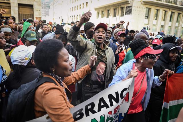 Protesters chant slogans as they march during a demonstration by the "March and March" and Operation Dudula movements marking an unofficial deadline set by citizen-led groups for undocumented foreign nationals to leave South Africa, in Cape Town, on June 30, 2026. South African police deployed to head off unrest and protests on June 30, 2026, the unofficial deadline set by anti-immigrant groups for undocumented foreign nationals to leave that has already pushed thousands to flee.
Officers were out in force to prevent violence and looting by the xenophobic groups, while hundreds of foreign nationals took refuge in several cities, urgently seeking help to leave. (Photo by RODGER BOSCH / AFP)