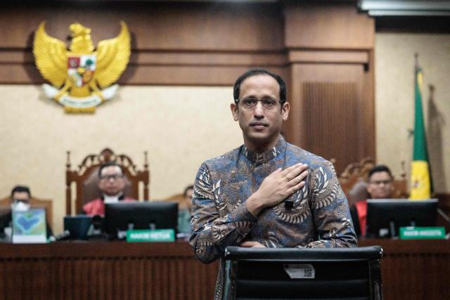 Nadiem Makarim, Indonesia's former education minister and co-founder of ride hailing company Gojek, reacts before a verdict hearing at the Central Jakarta District Court in Jakarta on June 30, 2026, in a corruption case related to the procurement of Chromebook laptops for schools during the Covid-19 pandemic. Judges found him guilty of corruption, sentencing him to 10 years in prison. The court also ordered Nadiem to pay a fine of 1 billion rupiah ($55,850) and 809 billion rupiah (more than $45 million) in restitution, or serve an additional prison term. (Photo by YASUYOSHI CHIBA / AFP)
