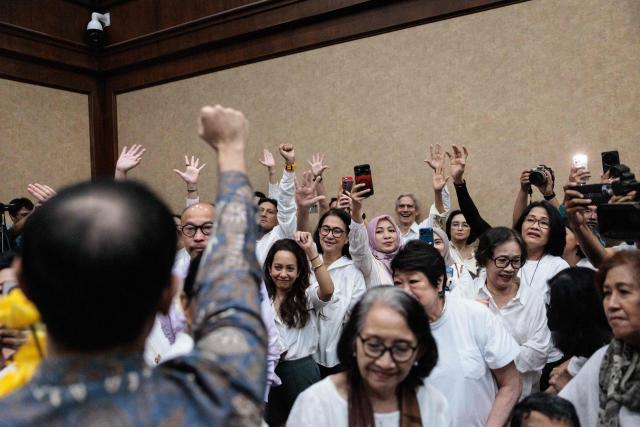 Nadiem Makarim, Indonesia's former education minister and co-founder of ride hailing company Gojek, gestures with his supporters and family members before a verdict hearing at the Central Jakarta District Court in Jakarta on June 30, 2026, in a corruption case related to the procurement of Chromebook laptops for schools during the Covid-19 pandemic. Judges found him guilty of corruption, sentencing him to 10 years in prison. The court also ordered Nadiem to pay a fine of 1 billion rupiah ($55,850) and 809 billion rupiah (more than $45 million) in restitution, or serve an additional prison term. (Photo by YASUYOSHI CHIBA / AFP)