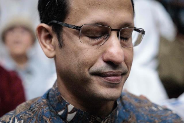 Nadiem Makarim, Indonesia's former education minister and co-founder of ride hailing company Gojek, closes his eyes as he waits for a verdict hearing at the Central Jakarta District Court in Jakarta on June 30, 2026, in a corruption case related to the procurement of Chromebook laptops for schools during the Covid-19 pandemic. Judges found him guilty of corruption, sentencing him to 10 years in prison. The court also ordered Nadiem to pay a fine of 1 billion rupiah ($55,850) and 809 billion rupiah (more than $45 million) in restitution, or serve an additional prison term. (Photo by YASUYOSHI CHIBA / AFP)