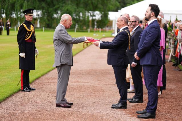 Lord Provost of Edinburgh Robert Aldridge (centre R) presents the keys to the city of Edinburgh to Britain's King Charles III (2nd L) during the traditional "Ceremony of the Keys" in the Gardens of the Palace of Holyroodhouse in Edinburgh, Scotland on June 30, 2026, on the first day of the king and queen's visit to Scotland. (Photo by Aaron Chown / POOL / AFP)