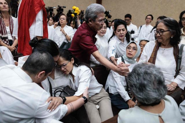 Family members of Nadiem Makarim, Indonesia's former education minister and co-founder of ride hailing company Gojek, comfort each other after he was found guilty in a corruption case related to the procurement of Chromebook laptops for schools during the Covid-19 pandemic at the Central Jakarta District Court in Jakarta on June 30, 2026. Judges found him guilty of corruption, sentencing him to 10 years in prison. The court also ordered Nadiem to pay a fine of 1 billion rupiah ($55,850) and 809 billion rupiah (more than $45 million) in restitution, or serve an additional prison term. (Photo by YASUYOSHI CHIBA / AFP)