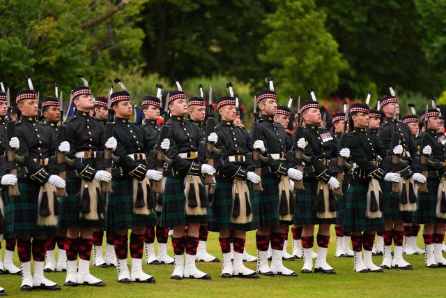 The guard of honour, Balaklava Company, 5th Battalion, the Royal Regiment of Scotland, stand at attention for the arrival of Britain's King Charles III for the traditional "Ceremony of the Keys" in the Gardens of the Palace of Holyroodhouse in Edinburgh, Scotland on June 30, 2026, on the first day of the king and queen's visit to Scotland. (Photo by Aaron Chown / POOL / AFP)