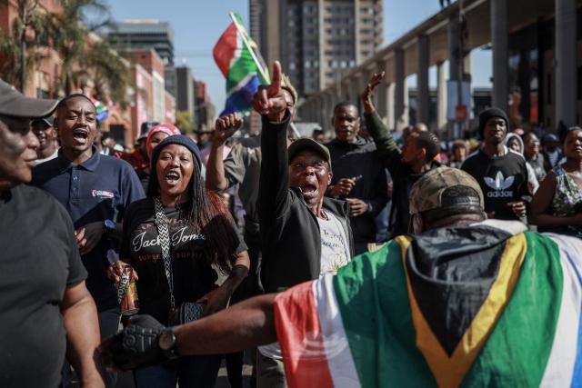 Protesters chant slogans as they march during a demonstration by the "March and March" and Operation Dudula movements marking an unofficial deadline set by citizen-led groups for undocumented foreign nationals to leave South Africa, in downtown Pretoria, on June 30, 2026. South African police deployed to head off unrest and protests on June 30, 2026, the unofficial deadline set by anti-immigrant groups for undocumented foreign nationals to leave that has already pushed thousands to flee.
Officers were out in force to prevent violence and looting by the xenophobic groups, while hundreds of foreign nationals took refuge in several cities, urgently seeking help to leave. (Photo by PHILL MAGAKOE / AFP)